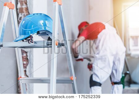 Hard Hat Left on the Ladder. Construction Safety Concept.