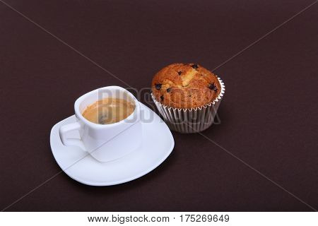 Classic espresso in white cup with cake and chocolate