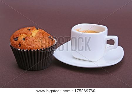 Classic espresso in white cup with cake and chocolate