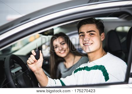 Young Couple With Keys To New Car