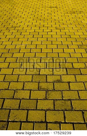 Una textura de fondo de un camino de ladrillos amarillos
