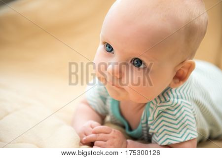 A cute dreamly little baby girl portrait on the brown background