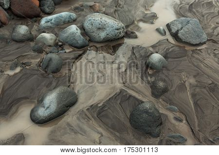 IL and stones on the bottom of river Studenaya. Kamchatka Peninsula.