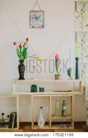 vase with tulips and candlesticks in spring backgroud.interiror
