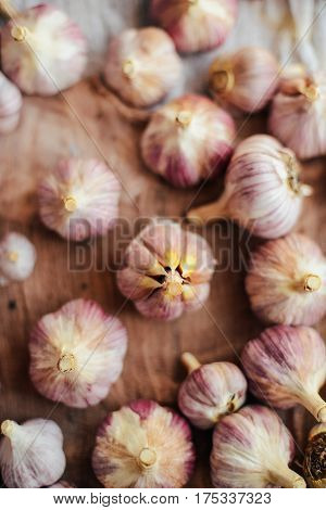 Close-up Garlic Bulbs And Garlic Cloves On Wodeen Background. Ga