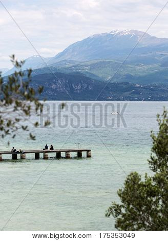 Landscape of the coast of Sirmione peninsula which divides the lower part of Lake Garda. It is a famous vacation place for a long time in northern Italy.