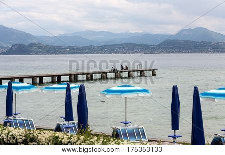 Landscape of the coast of Sirmione peninsula which divides the lower part of Lake Garda. It is a famous vacation place for a long time in northern Italy.
