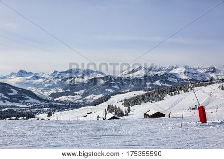 Empty ski domain located at high altitude in Alps in Beaufortain Massif in Haute-Savoie close to Mont Blanc. In the distance can be seen Chaine des Aravis above the clouds and villages.