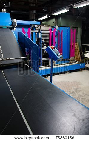 Textile fabric manufacturing machines in work. Hoisery production