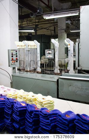 Machinery and equipment in a spinning production company interior design. Hoisery factory. Textile fabric. Socks production