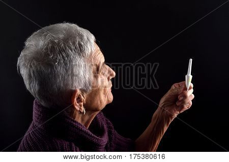 Senior woman Laxative on a black background