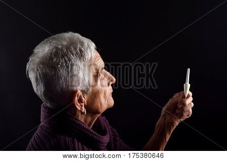 Senior woman Laxative on a black background