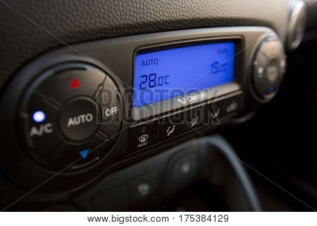 Closeup of Modern Air Conditioning and Heating Control Panel of a Car