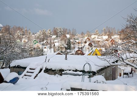 suburban settlement small wooden houses winter view on roofs covered by snow