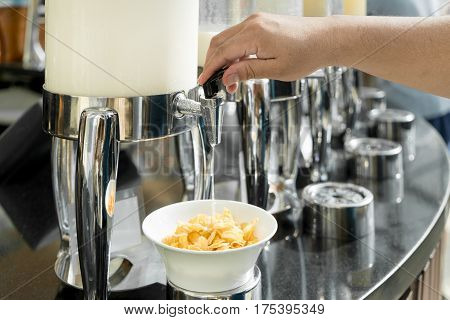 Cereals and fresh maik on the table in buffet breakfast in the restaurant. Healthy food.