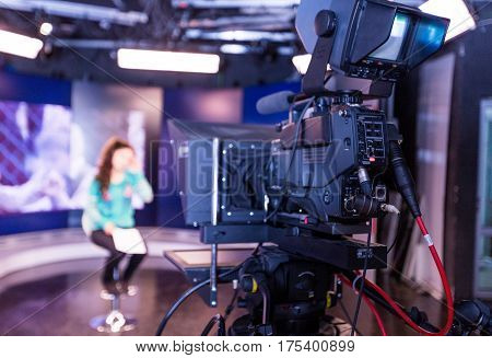 Closeup of a Video Camera Filming a TV Host