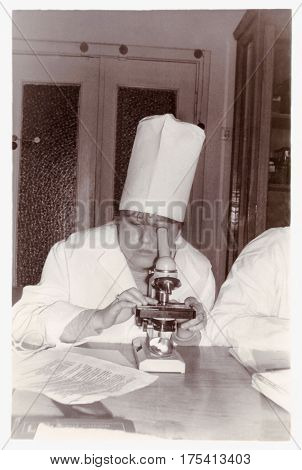 VITEBSK BELARUS - CIRCA 1987: Student of medical faculty of Vitebsk Medical Institute examines preparation under microscope at Department of Histology (1987) Belarus