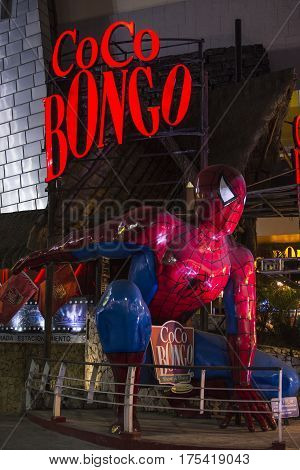 CANCUN MEXICO - MARCH 1 2017: A huge Spiderman figure kneels in landing position in front of the famous Coco Bongo nightclub in Cancun.