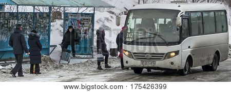 Kazakhstan, Ust-Kamenogorsk, 24 february 2017: Bus stop, people at the bus stop, public transport, bus arrival
