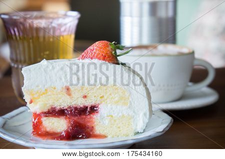 coffee cup and delicious cake strawberry and relax time moblie on table in coffee shop
