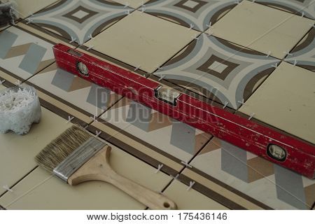 The Working Tool Of The Specialist For Laying Tiles, A Device For Determining The Level, A Brush, Cr