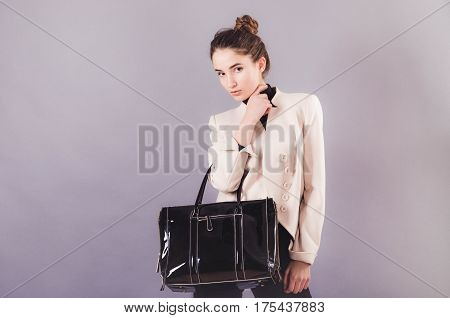 Front View Of A Young Smiling Business Woman With Ladies Bag.