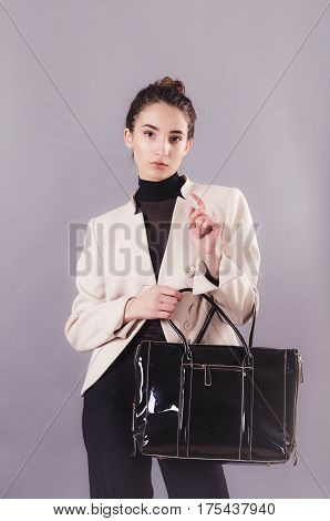 Front View Of A Young Smiling Business Woman With Ladies Bag.