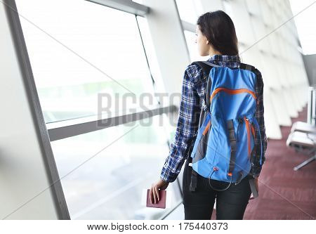 Pretty young female passenger at the airport (shallow DOF; color toned image)