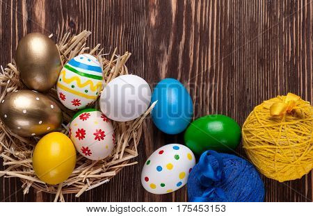 Colorful easter edds on a brown wooden table