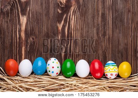 Colorful easter edds on a brown wooden table
