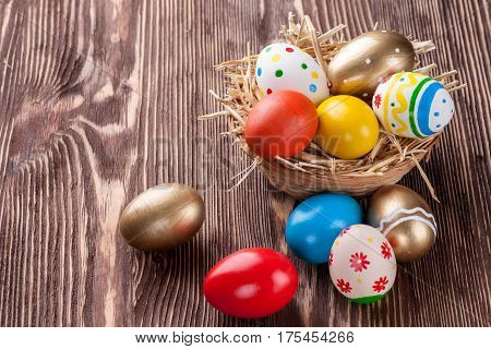 Colorful easter edds on a brown wooden table