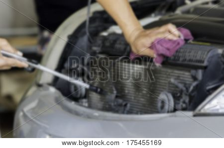 Blurry image Man was cleaning and wiping car radiator fin and car engine with Hand and Violet Microfiber Cloth and Air gun. Air pressure Car cleaning Car Washing