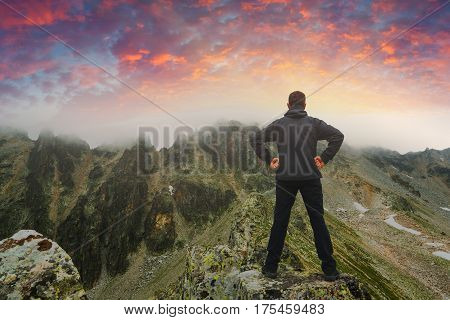 Hiker Stays On A Rocky Ridge