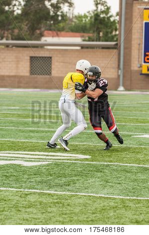 Football cornerback playing man to man coverage on wide receiver.