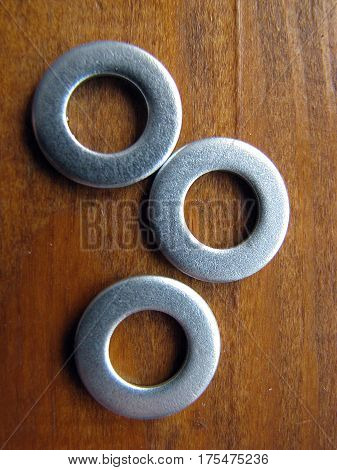 Household goods. Metal washers on a wooden background