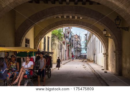 Havana, Cuba on December 23, 2015: Streetscene of Cuban people in bicycle taxi
