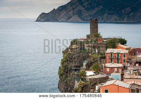 Old medieval watchtower and old houses on cliffs of  Vernazza town at Cinque Terre national park, Italy