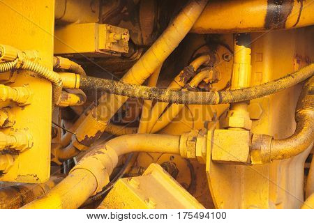 motor mechanics yellow excavator tractor engine close-up hydraulic machines