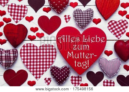 Red Heart Texture With German Text Alles Liebe Zum Muttertag Means Happy Mothers Day. White Wooden Background. Textile Hearts Which Are Dotted and Striped. Greeting Card