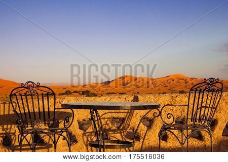 Table and chair on hotel roof top terrace in Sahara desert,  Morocco