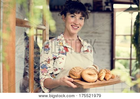 Woman with bread at pastry shop order