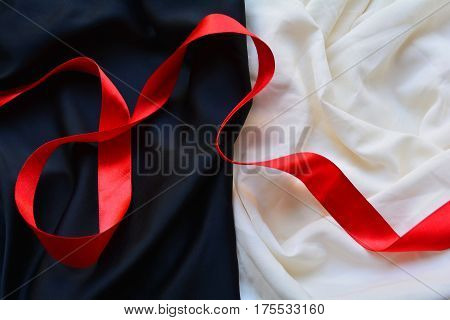 red silk ribbon on a black and white background