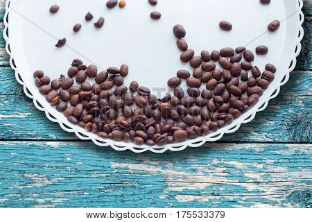Coffee Beans On A White Plastic Plate. On Beautifull Wooden Background. Love. Insparation. On White