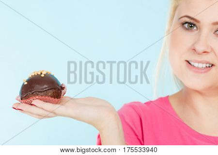 Woman Holding Chocolate Cupcake About To Bite