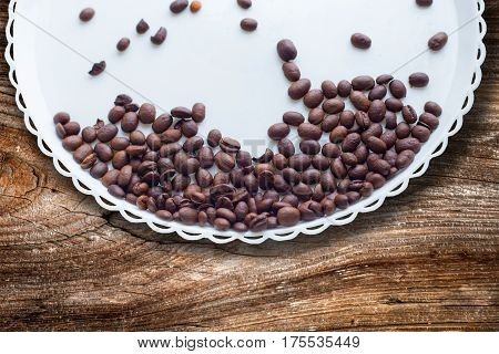 Coffee Beans On A White Plastic Plate. On Beautifull Wooden Background. Love. Insparation. On White