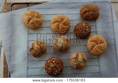 variety of small breads with seeds on grille