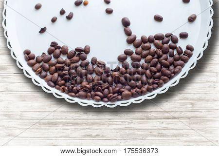 Coffee Beans On A White Plastic Plate. On Beautifull Wooden Background. Love. Insparation. On White