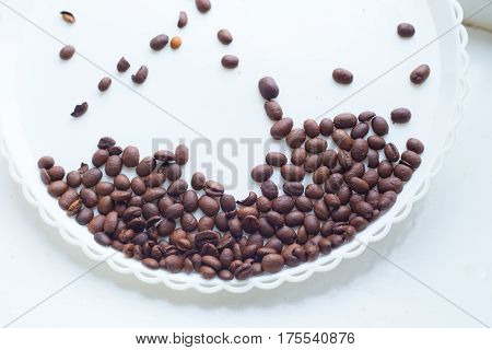 Coffee Beans On A White Plastic Plate. Beautifull Background. Love. Insparation. On White Plate.