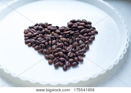 Coffee Beans In Form Of Heart On Beautifull Background. Love. Insparation. On White Plate.