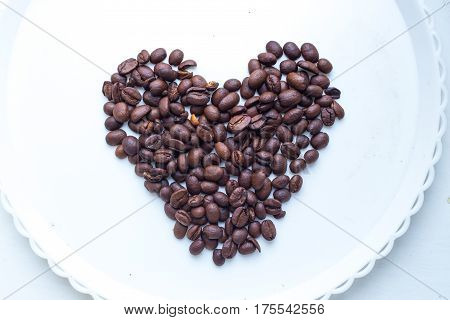 Coffee Beans In Form Of Heart On Beautifull Background. Love. Insparation. On White Plate.